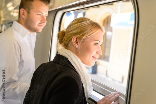 Photo: Man and woman looking out train window Man and woman looking out train window