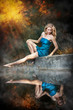 Photo of romantic woman in blue dress  in fairy forest