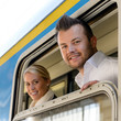 Man and woman in train looking window