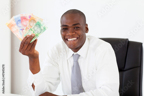 Photo: african businessman with south african cash notes african businessman with south african cash notes