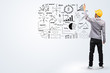 Photo: Engineer drawing business plan concept idea on whiteboard. Engineer drawing business plan concept idea on whiteboard.
