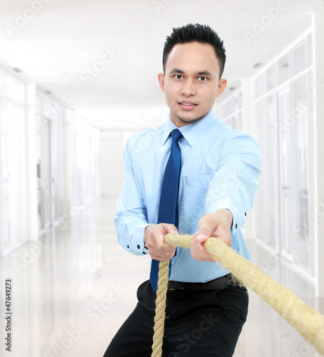 Photo: man pulling a rope man pulling a rope