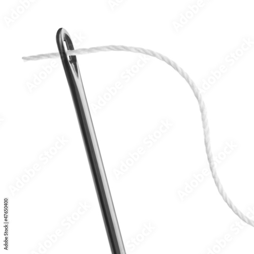 Photo: needle and thread on a white background needle and thread on a white background