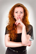Woman with finger over mouth