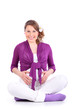 Smiling pregnant woman sits on floor and holds her belly