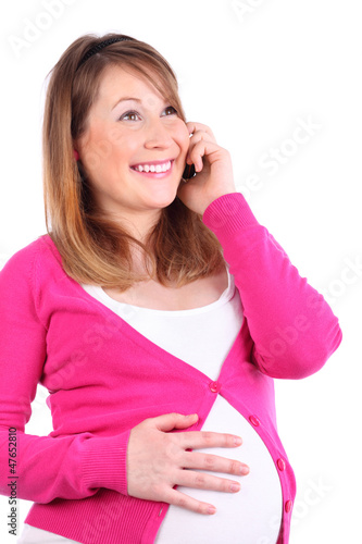 Photo: Happy pregnant woman talks at cell phone isolated on white Happy pregnant woman talks at cell phone isolated on white