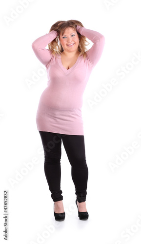 Photo: Smiling beautiful woman puts her hands in hairs isolated Smiling beautiful woman puts her hands in hairs isolated