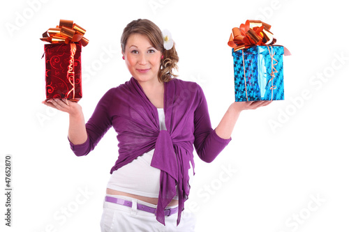 Photo: Smiling pregnant woman holds red and blue boxes with gift Smiling pregnant woman holds red and blue boxes with gift