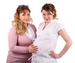 Pregnant woman in white and her girlfriend touching her stomach