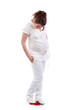 Pregnant woman in white stands on red balance and looks