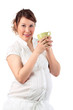 Pregnant woman in white holds cup isolated on white background.