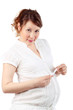 Pregnant woman in white holds thermometer isolated on white