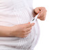 Belly of pregnant woman in white holding thermometer isolated