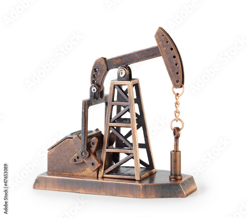 Photo: Metal mechanical miniature oil derrick isolated on white Metal mechanical miniature oil derrick isolated on white