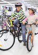 Foto: Boy and girl in helmets sit on bright bicycles Boy and girl in helmets sit on bright bicycles