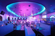 People in illuminated hall