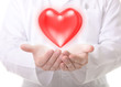Photo: Male doctor showing a red heart Male doctor showing a red heart