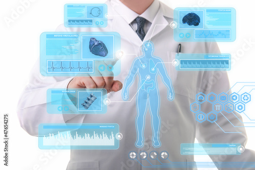 Photo: Male doctor working on a futuristic touchscreen display Male doctor working on a futuristic touchscreen display
