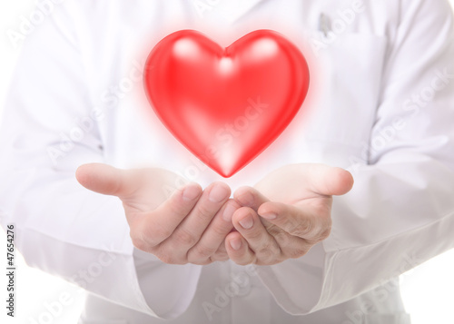 Photo: Male doctor showing a red heart Male doctor showing a red heart