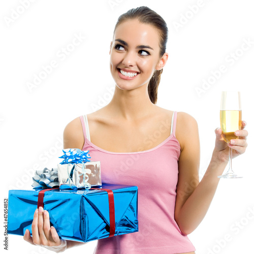 Photo: Young woman with gift and champagne, isolated Young woman with gift and champagne, isolated