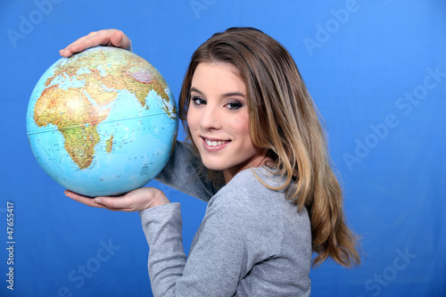 Photo: Attractive young woman holding a globe Attractive young woman holding a globe