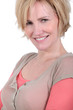 Closeup of a smiling woman with short blonde hair