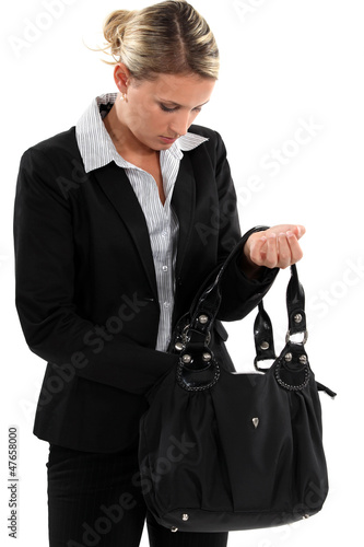 Photo: businesswoman searching through her bag businesswoman searching through her bag