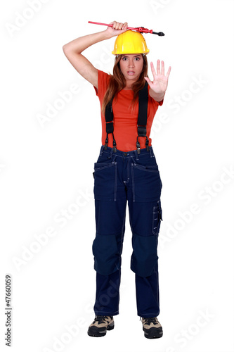 Photo: A female construction worker doing a stop sign. A female construction worker doing a stop sign.