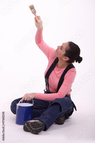 Photo: Woman painting a wall Woman painting a wall