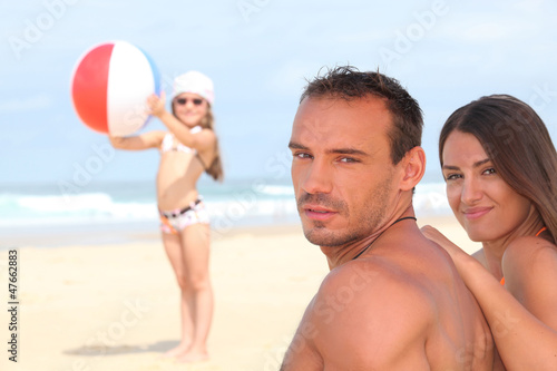 Photo: Family relaxing at the beach Family relaxing at the beach