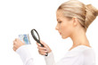 woman with magnifying glass and euro cash money