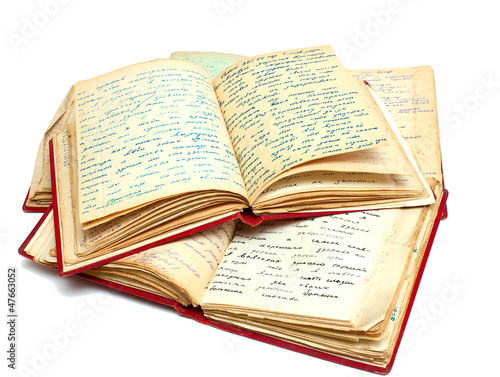 Photo: stack of old books with red covers and one of them open on top stack of old books with red covers and one of them open on top