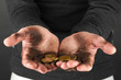 homeless man holding a coins, close-up