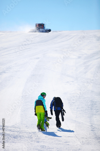 Photo: Two snowboarders walking up slope Two snowboarders walking up slope
