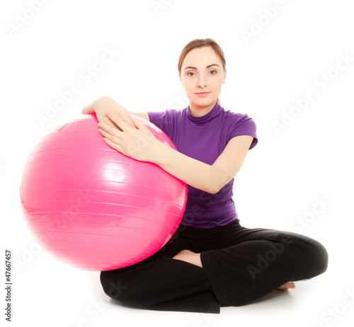 Photo: Young beautiful woman with gymnastic ball on a white background Young beautiful woman with gymnastic ball on a white background