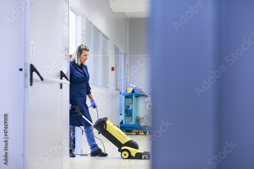 Photo: Women at workplace, professional female cleaner washing floor in Women at workplace, professional female cleaner washing floor in