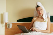 young business woman working at the note book in the bed