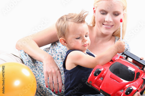 Photo: Mum and her son playing with toy car Mum and her son playing with toy car