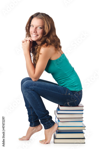 Photo: Student sitting on stack of books Student sitting on stack of books