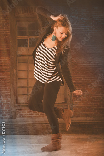 Photo: young dancer dancing under sun beams young dancer dancing under sun beams