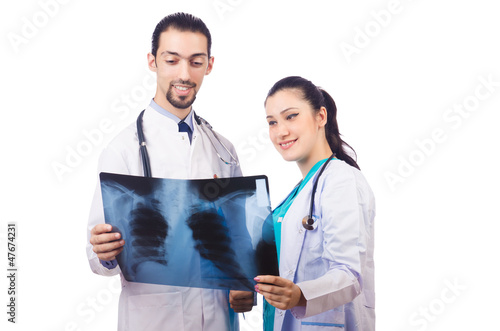 Photo: Two doctors looking at x-ray image on white Two doctors looking at x-ray image on white