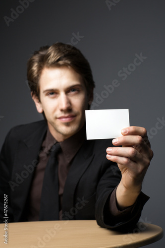 Photo: Young man with a business card Young man with a business card