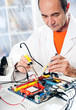 Senior tech tests electronic equipment