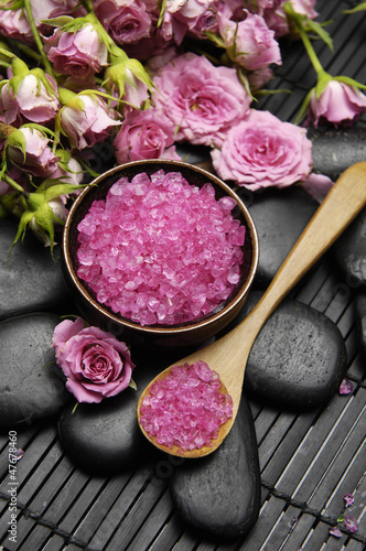 Photo: Beautiful pink orchid with salt in spoon and stones on mat Beautiful pink orchid with salt in spoon and stones on mat