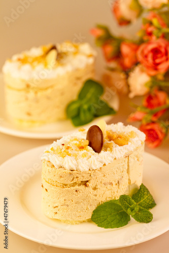 Photo: Italian dessert tiramisu with cream and chocolate. In the backgr Italian dessert tiramisu with cream and chocolate. In the backgr