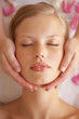 Gorgeous young woman receiving a facial massage