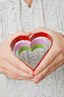 Heart symbols held in hands