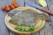 Flounder raw fish on cutting board in kitchen