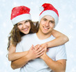 Beautiful Christmas couple in Santa hats