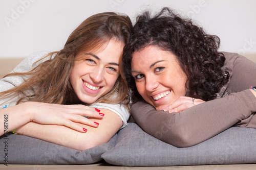 Photo: Two Beautiful Women Lying Down with Pillow Two Beautiful Women Lying Down with Pillow